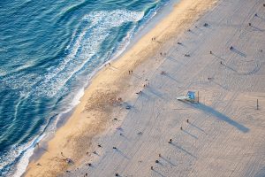 The beach is busy near the pier - but 100 yards away it's dead quiet