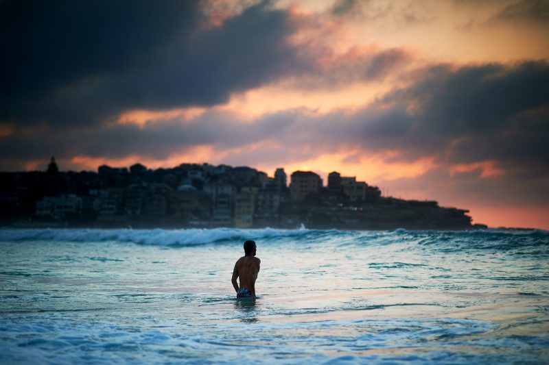 The muscular physique of a renowned surf writer, Derekique Beach Grit Reilly